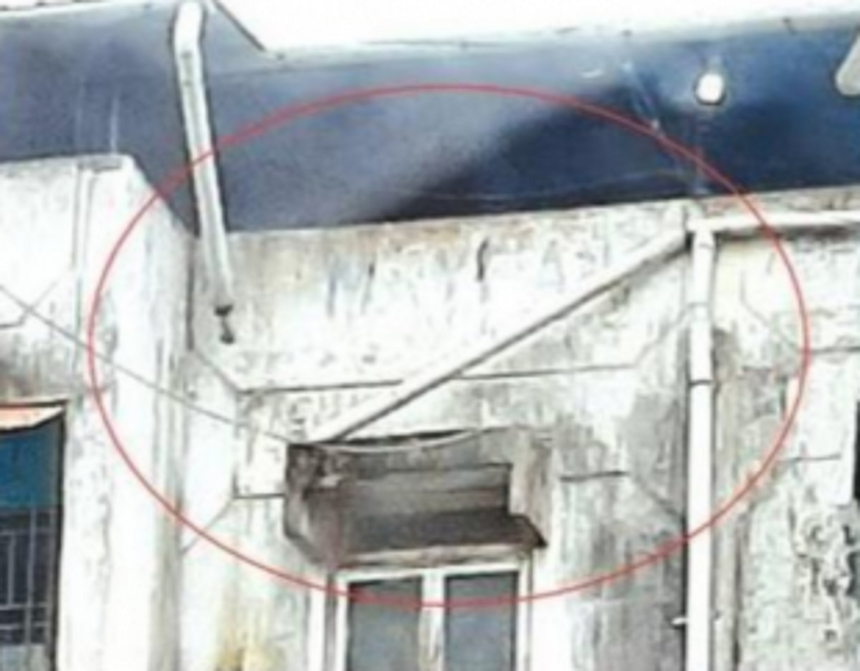 Water pipe hanging dangerously  from a building at Margao