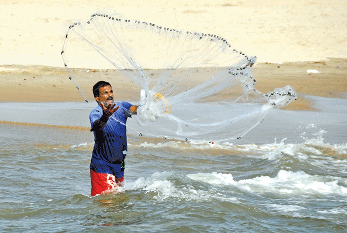 With the ban on mechanised fishing taking effect, a fisherman flungs his fishing net, (locally known as Pagear) hoping for a catch at Baga.
