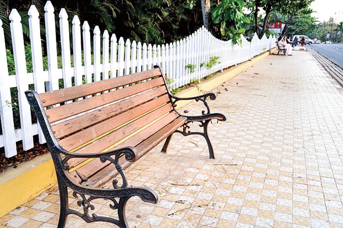 stripped: bench with missing wooden strips along the pavement near the Goa Science Centre on the