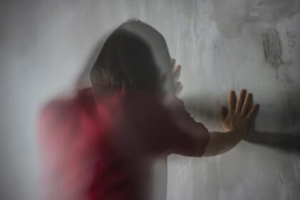 rear view woman standing against wall 1048944 28886198