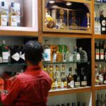 A salesman arranges liquor bottles inside a liquor 1779029333273 1