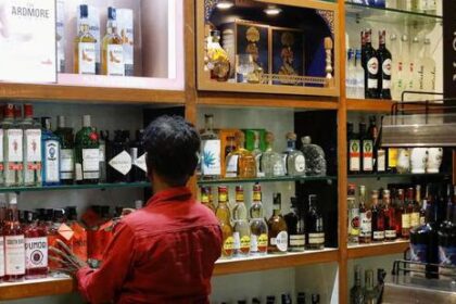 A salesman arranges liquor bottles inside a liquor 1779029333273 1
