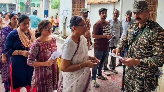Voters stand in que to vote in the 2026 West Bengal Assembly election